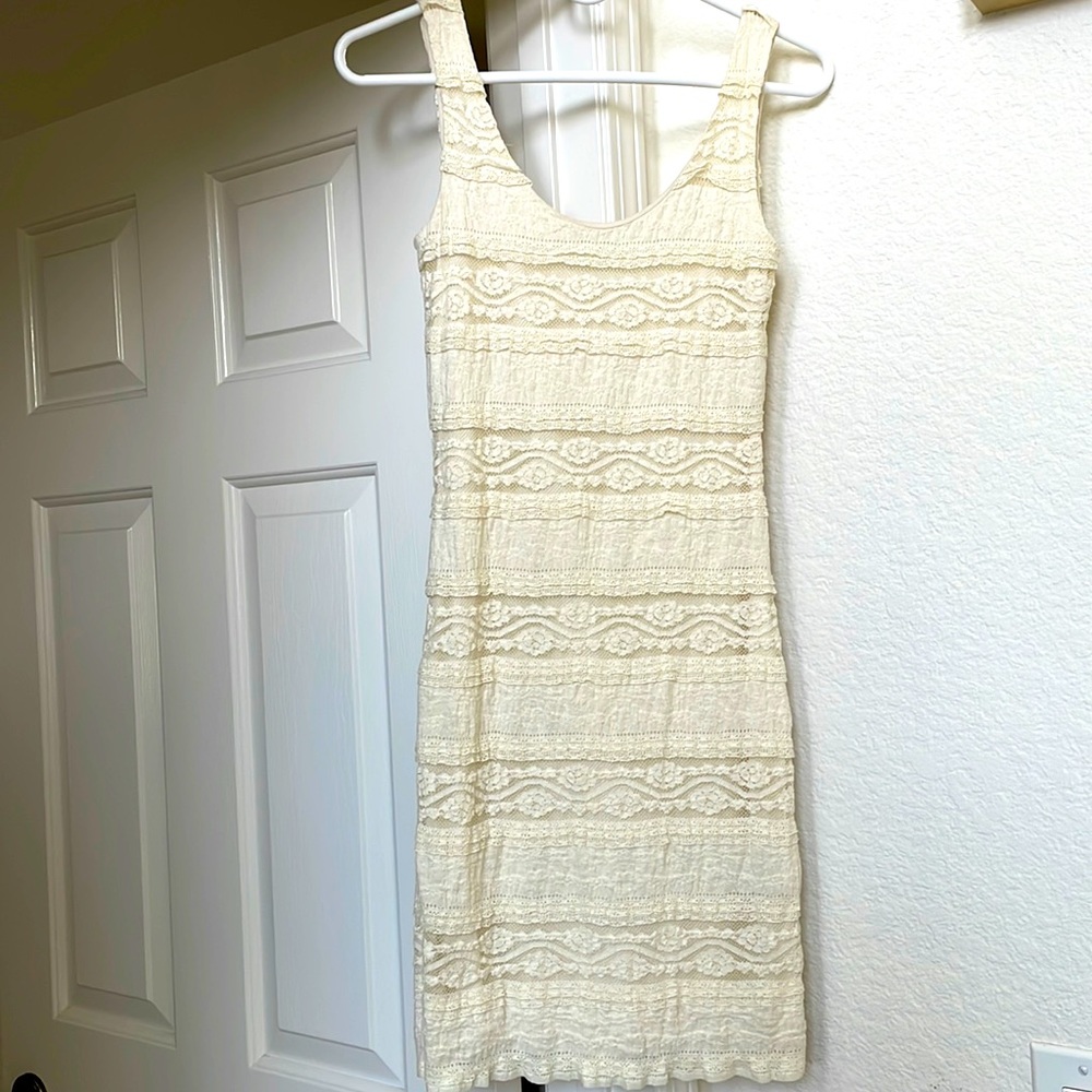 Cream color, lace, dress. Material stretches. It is form fitting and flattering.
